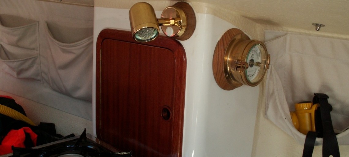 Traditional brass LED light on Port and Starboard storage units with brass barometer and brass clock mounted on teak pad. 40th bithday present from my Mum and Dad.